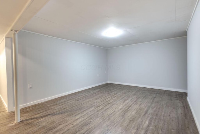 empty room with baseboards and wood finished floors