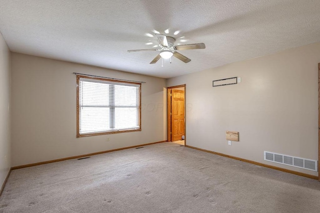 unfurnished room with a textured ceiling, visible vents, baseboards, ceiling fan, and light carpet