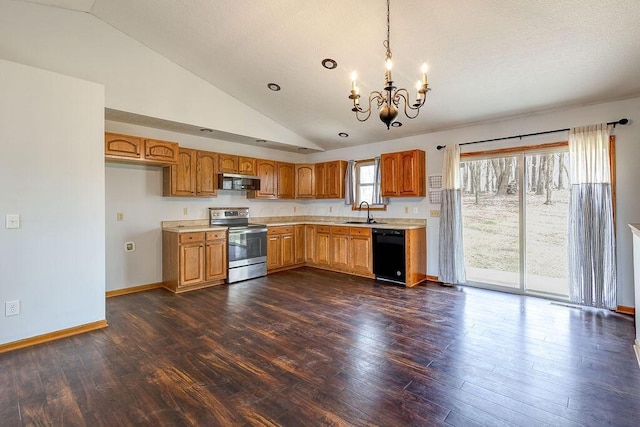 kitchen featuring light countertops, a chandelier, a sink, dark wood-style floors, and appliances with stainless steel finishes