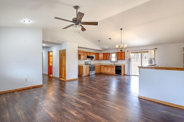 kitchen with light countertops, a sink, appliances with stainless steel finishes, ceiling fan with notable chandelier, and dark wood-style flooring