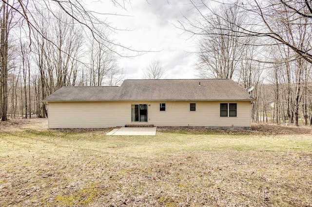 rear view of property with a lawn and a patio area