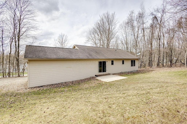 rear view of house with a yard