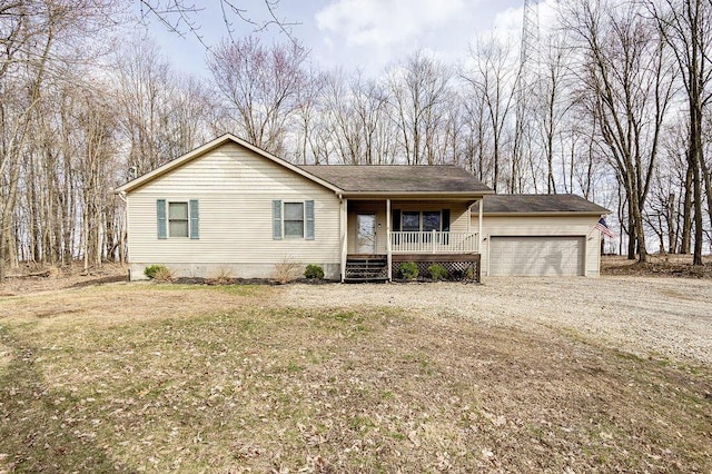 ranch-style home featuring covered porch, driveway, a garage, and a shingled roof