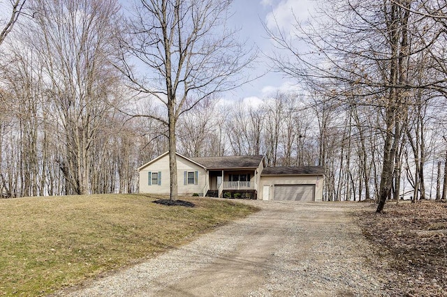 ranch-style home with a porch, a front lawn, an attached garage, and dirt driveway