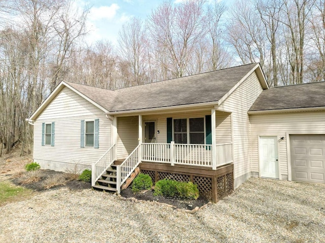 ranch-style home featuring an attached garage, a shingled roof, and a porch
