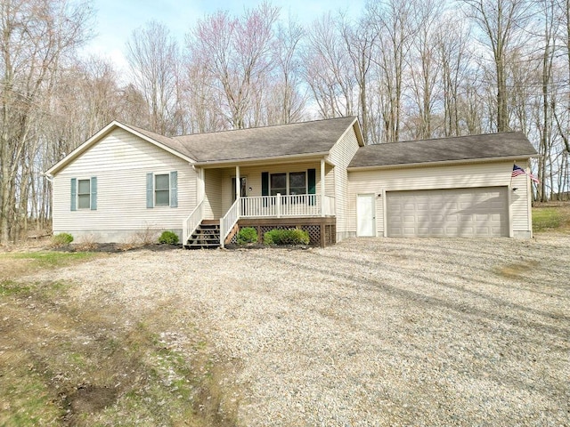 ranch-style house with a porch, driveway, and a garage