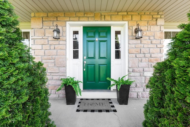 view of exterior entry featuring brick siding