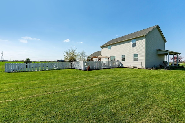 back of house featuring fence and a yard