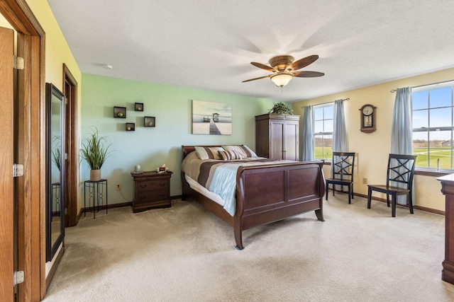 bedroom featuring light carpet, baseboards, ceiling fan, and multiple windows