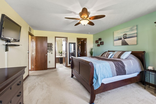 bedroom with light carpet, baseboards, visible vents, ceiling fan, and ensuite bath