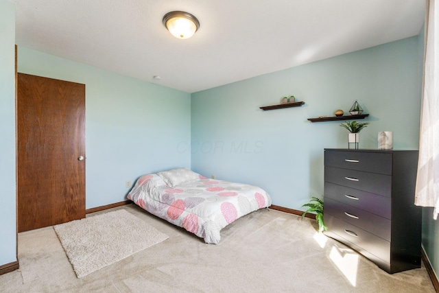 carpeted bedroom with baseboards