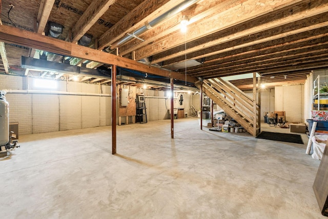 basement with electric panel and stairs