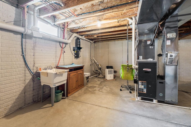 below grade area featuring heating unit and a sink