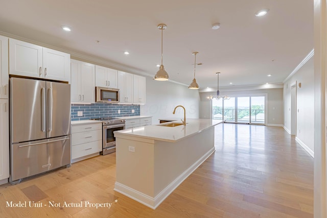 5177 Highpointe Lakes Dr Unit 9403, Westerville, OH 43081 - kitchen featuring a sink, light wood finished floors, white cabinetry, stainless steel appliances, and ornamental molding