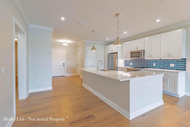 5177 Highpointe Lakes Dr Unit 9403, Westerville, OH 43081 - kitchen with white cabinetry, a spacious island, a sink, light wood finished floors, and appliances with stainless steel finishes