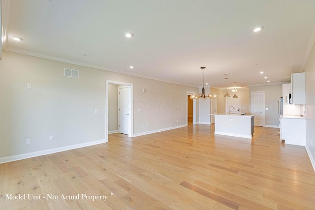 5177 Highpointe Lakes Dr Unit 9403, Westerville, OH 43081 - unfurnished living room featuring visible vents, crown molding, light wood finished floors, recessed lighting, and an inviting chandelier