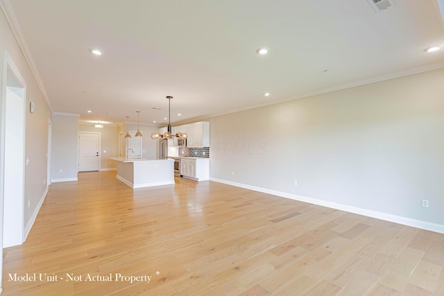 5177 Highpointe Lakes Dr Unit 9403, Westerville, OH 43081 - unfurnished living room with crown molding, recessed lighting, an inviting chandelier, a sink, and light wood-style flooring