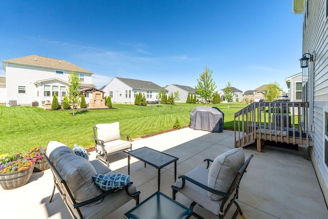 view of patio featuring a grill, outdoor lounge area, a residential view, and cooling unit