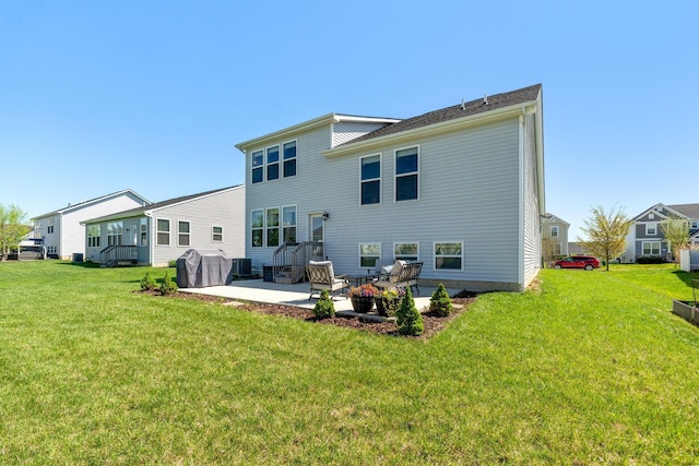 rear view of house with a yard and a patio area