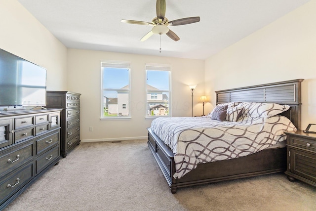 bedroom featuring baseboards, ceiling fan, and light colored carpet