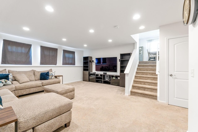 living area with recessed lighting, stairway, baseboards, and carpet