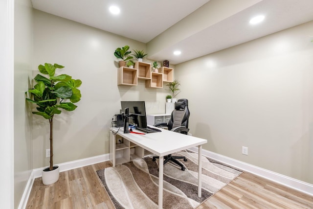 office space featuring recessed lighting, baseboards, and light wood-style floors