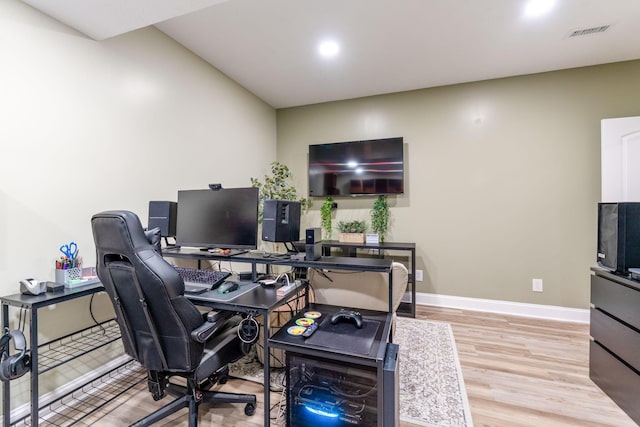 office space featuring baseboards, recessed lighting, wood finished floors, and visible vents