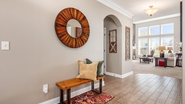 116 Coffeetree Ct, Pickerington, OH 43147 - hallway featuring arched walkways, baseboards, ornamental molding, and wood finished floors