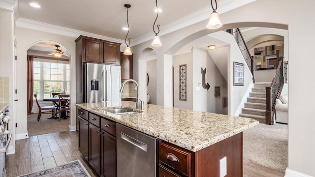 116 Coffeetree Ct, Pickerington, OH 43147 - kitchen with a sink, stainless steel appliances, a ceiling fan, arched walkways, and pendant lighting