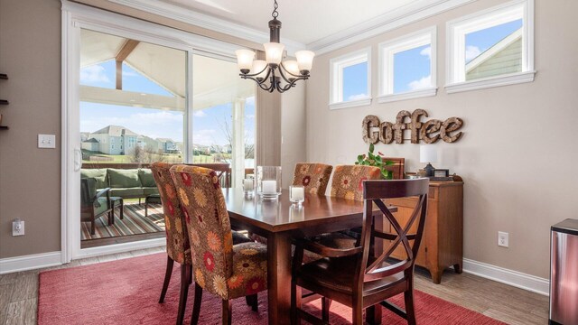 116 Coffeetree Ct, Pickerington, OH 43147 - dining space with a chandelier, baseboards, crown molding, and wood finished floors