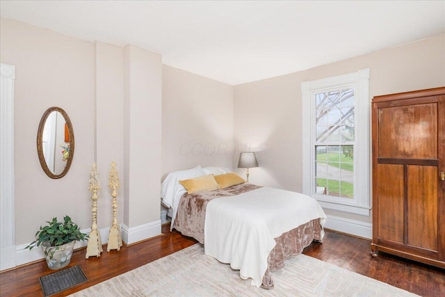 8056 Summit Rd SW, Pataskala, OH 43062 - bedroom featuring visible vents, baseboards, and wood finished floors