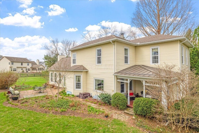 8056 Summit Rd SW, Pataskala, OH 43062 - back of house with a chimney, a porch, a yard, fence, and a shingled roof
