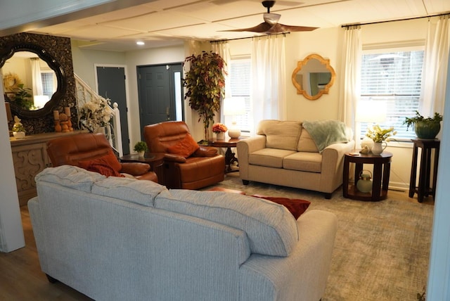 living area with wood finished floors and a ceiling fan