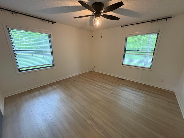 7326 State Route 19 Unit 2, Lot 321, Mount Gilead, OH 43338 - empty room featuring a textured ceiling, ceiling fan, baseboards, and wood finished floors