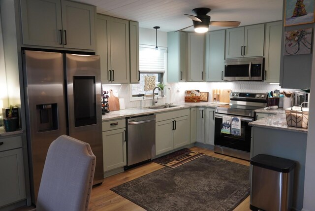 7326 State Route 19 Unit 2, Lot 321, Mount Gilead, OH 43338 - kitchen featuring appliances with stainless steel finishes, a sink, a ceiling fan, light stone countertops, and decorative backsplash