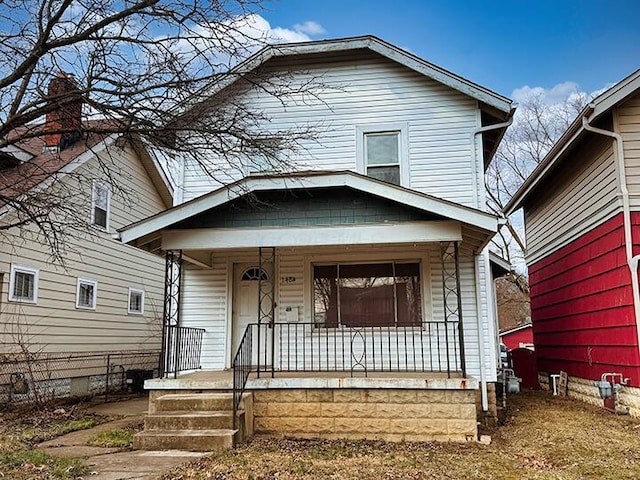 view of front of home featuring fence and a porch