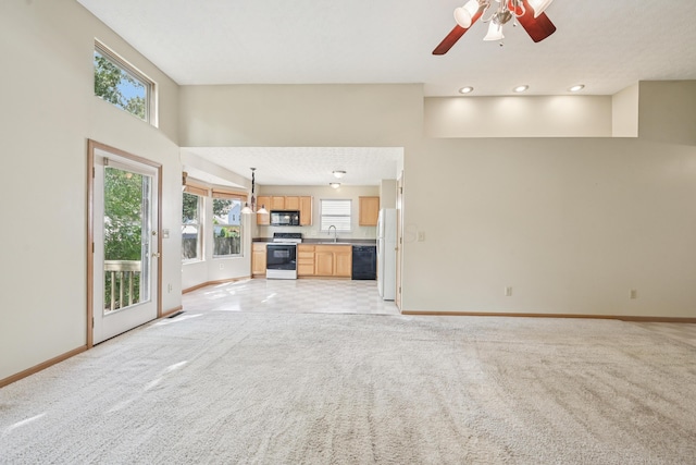 3092 Andrew James Dr, Hilliard, OH 43026 - unfurnished living room featuring healthy amount of natural light, a ceiling fan, light colored carpet, and recessed lighting