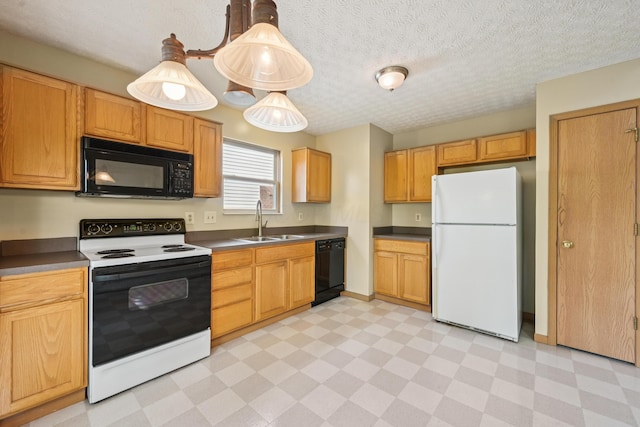 3092 Andrew James Dr, Hilliard, OH 43026 - kitchen featuring black appliances, light flooring, dark countertops, and a textured ceiling