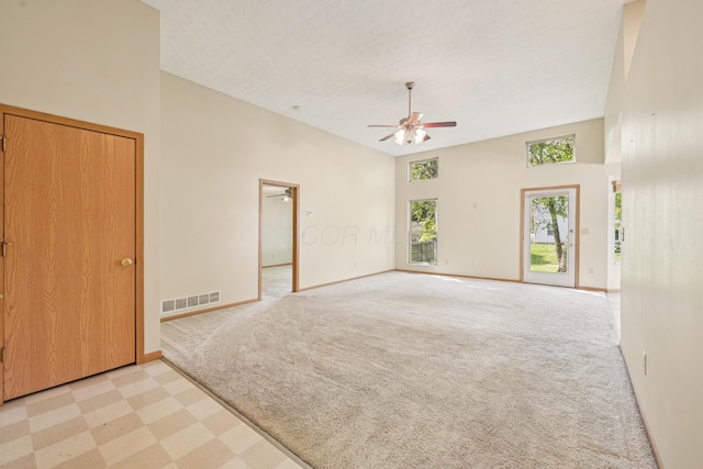 3092 Andrew James Dr, Hilliard, OH 43026 - spare room with ceiling fan, light colored carpet, a towering ceiling, and light flooring