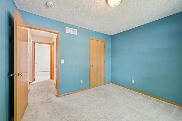 3092 Andrew James Dr, Hilliard, OH 43026 - unfurnished bedroom featuring carpet floors, a closet, and a textured ceiling