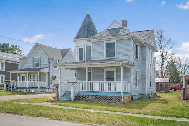 victorian home featuring a chimney, a porch, a shingled roof, and a front lawn
