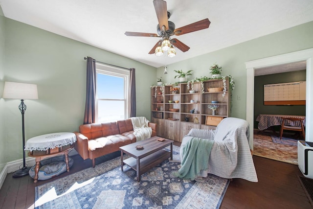 living room featuring wood-type flooring, a ceiling fan, and baseboards