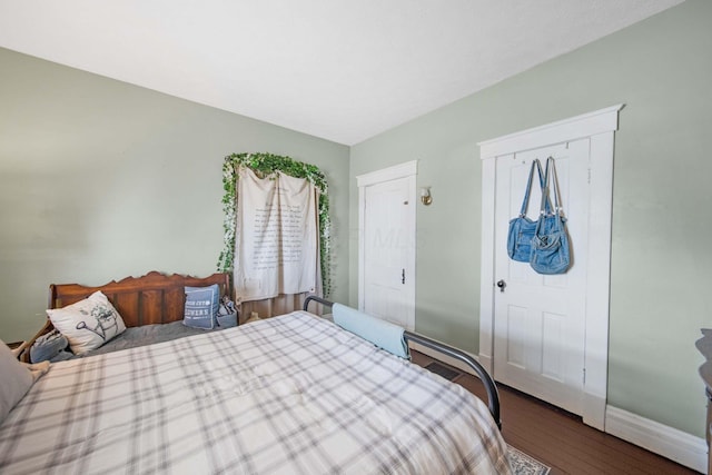 bedroom featuring baseboards and wood finished floors