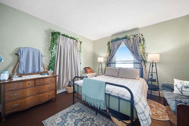 bedroom with dark wood finished floors