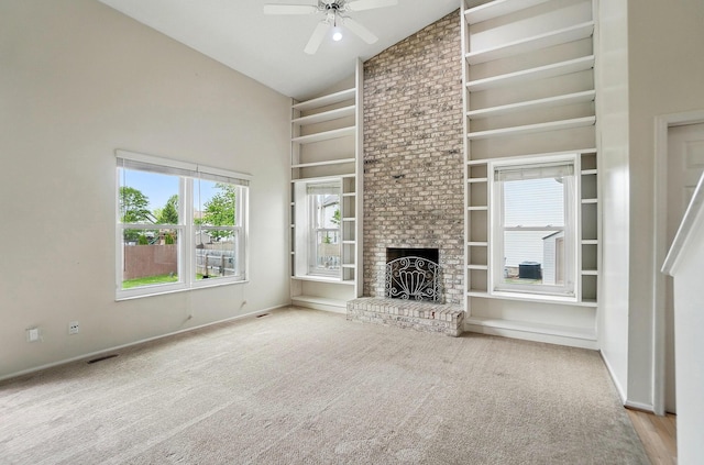 unfurnished living room with high vaulted ceiling, ceiling fan, baseboards, carpet floors, and built in features