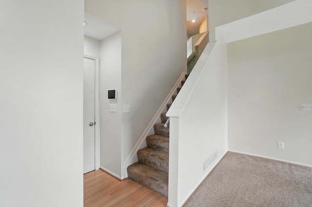 stairs featuring baseboards and wood finished floors