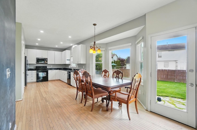 dining space with light wood-style floors, a chandelier, recessed lighting, and baseboards