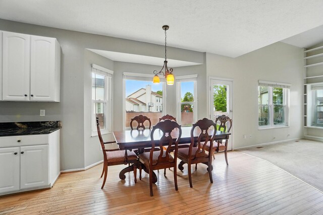 dining room featuring baseboards and light wood finished floors