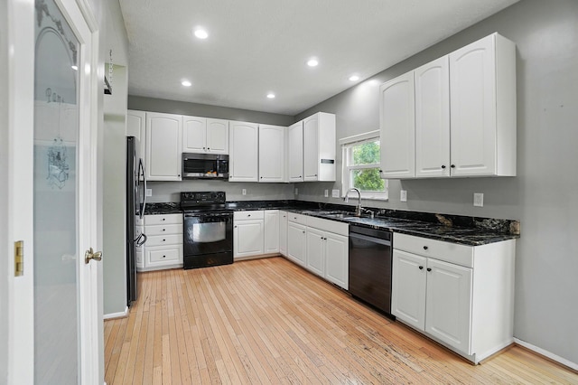 kitchen with black appliances, light wood finished floors, white cabinetry, and recessed lighting