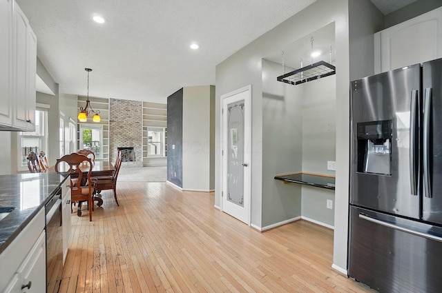 kitchen with appliances with stainless steel finishes, baseboards, light wood-type flooring, white cabinetry, and recessed lighting